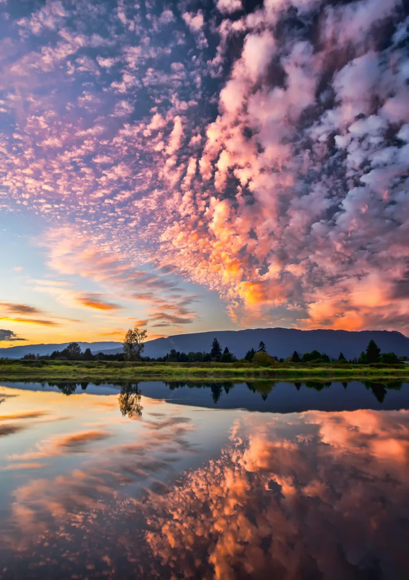 Sunset clouds mirrored in still water