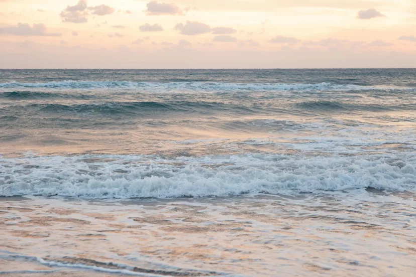 Gentle waves running up a sandy beach