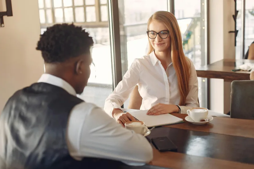 A one-to-one coaching session at a table by a window